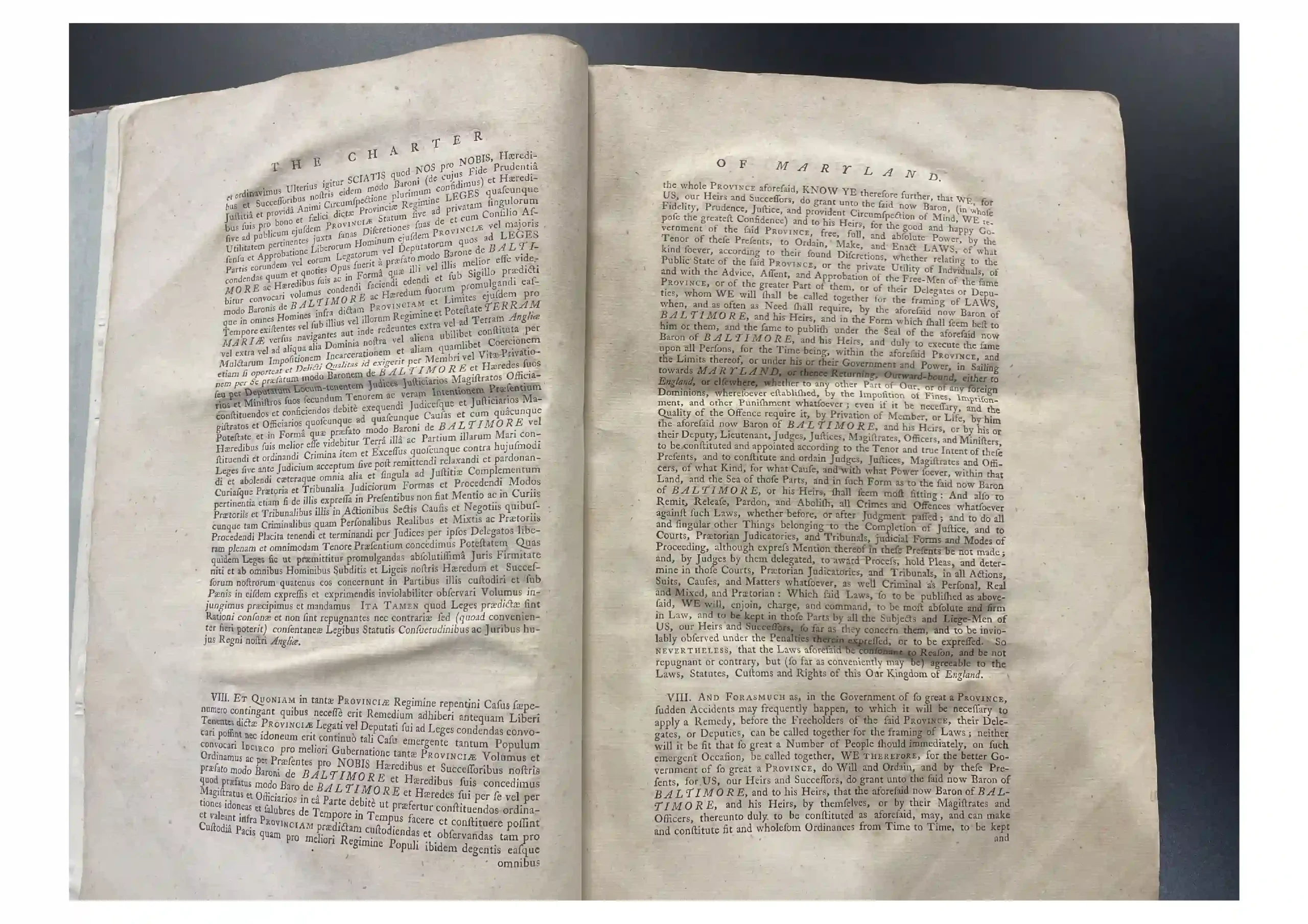 Open an old book with two pages of dense legal text, header reads 'THE CHARTER'. The pages are aged and worn.