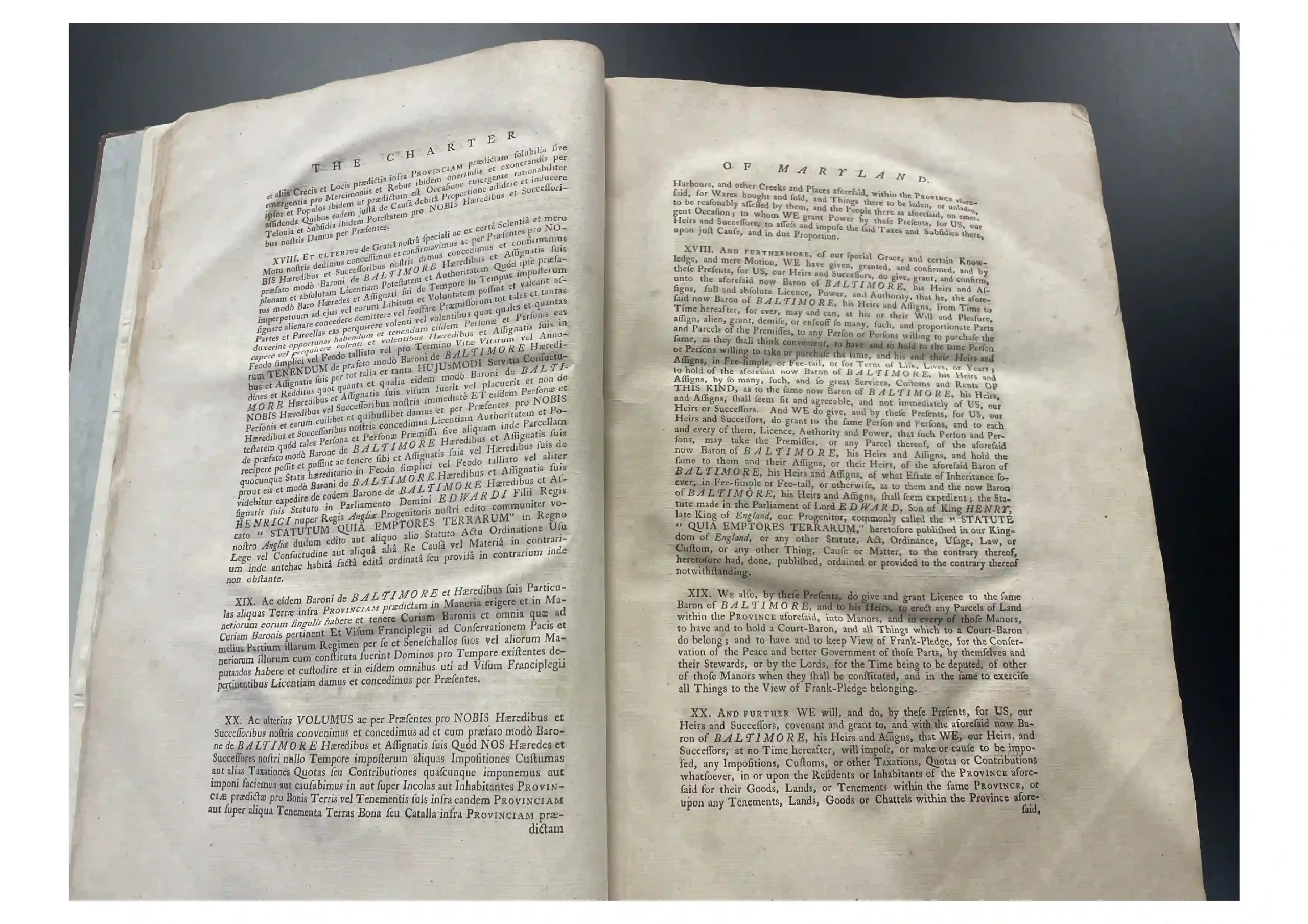 Open antique book laid flat showing two facing pages filled with dense Latin text, worn margins evident.