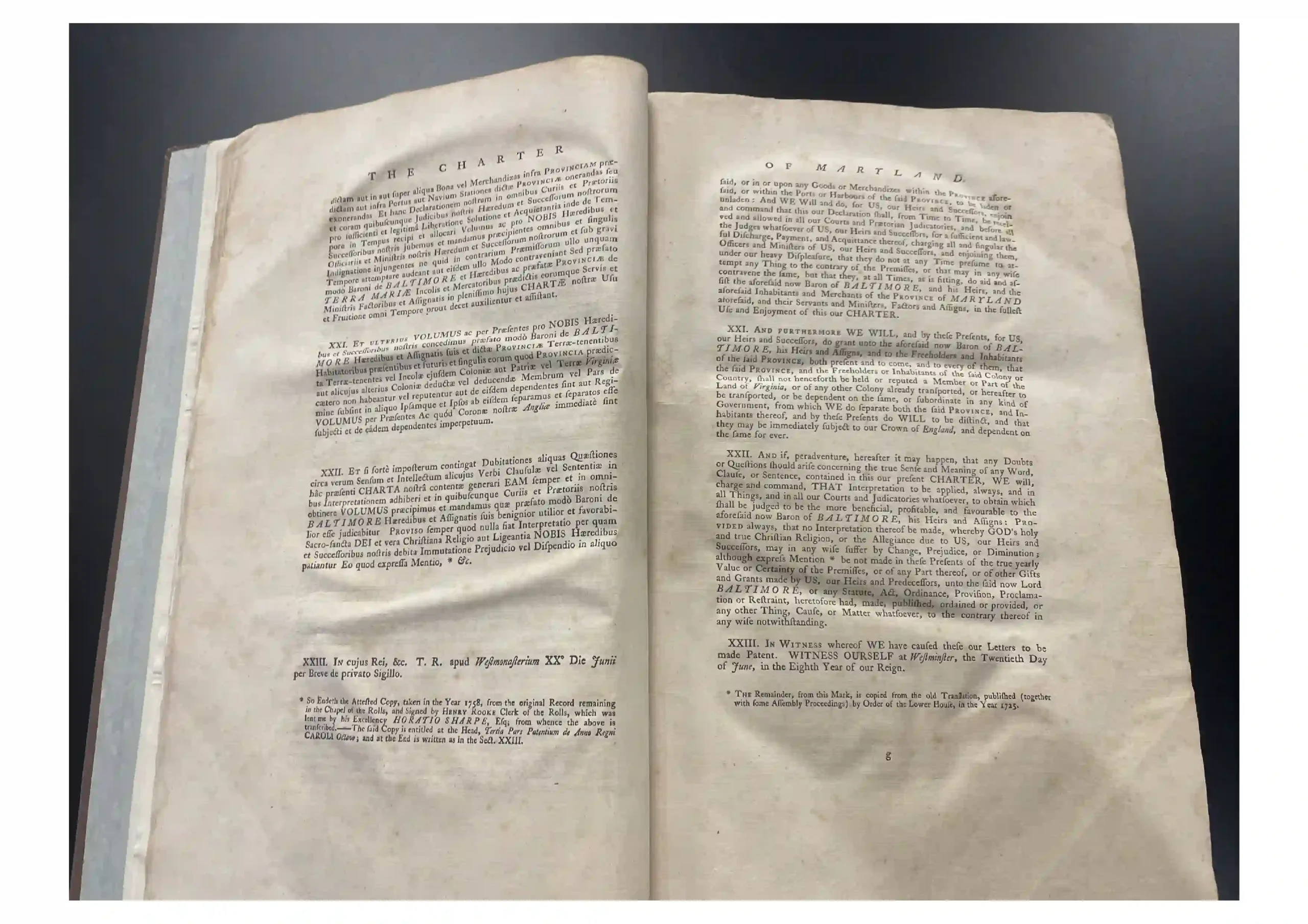Open old book laid flat, showing a two-page spread with dense black text on aged paper.